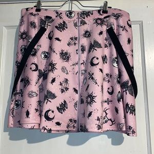 Pink and black skirt with pockets and suspenders, detail, and zipper front